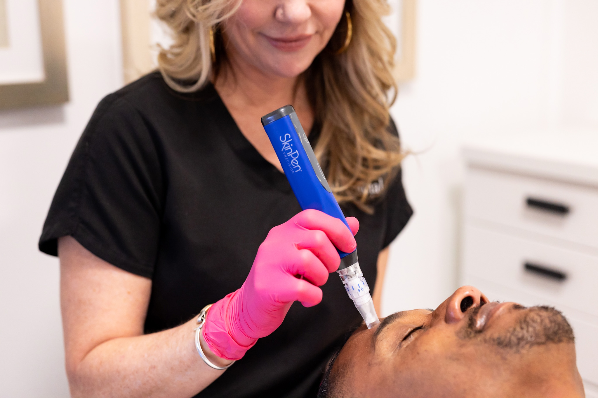 a woman treating her client with the SkinPen Microneedling theraphy